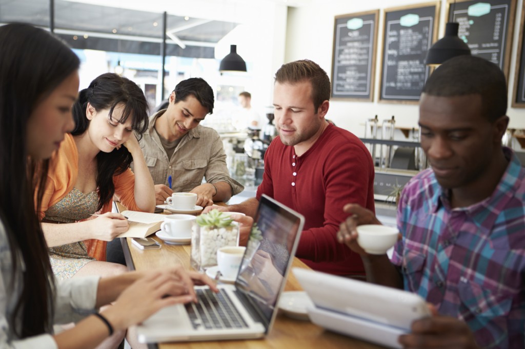 Customers In Busy Coffee Shop